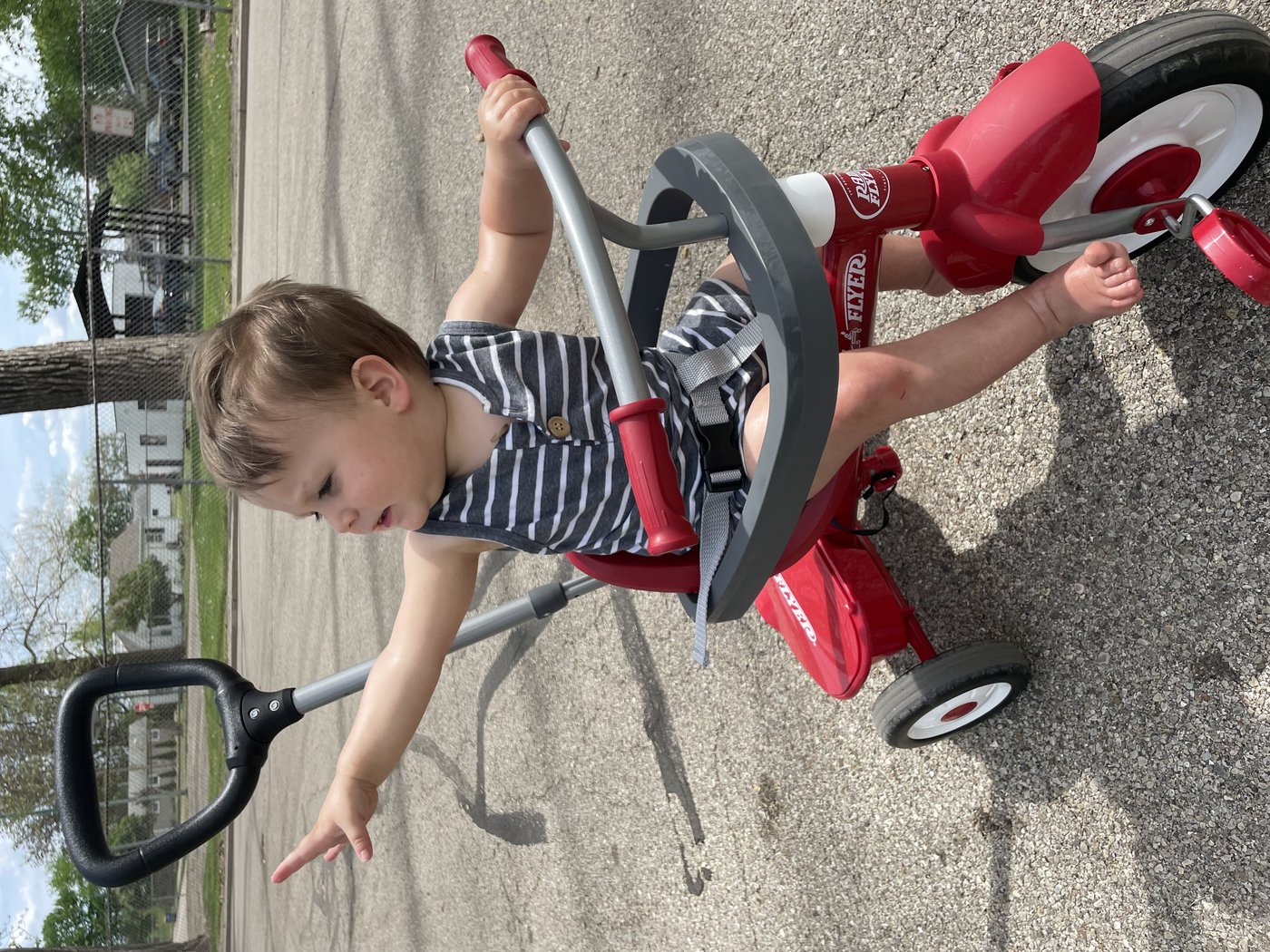 child riding tricycle