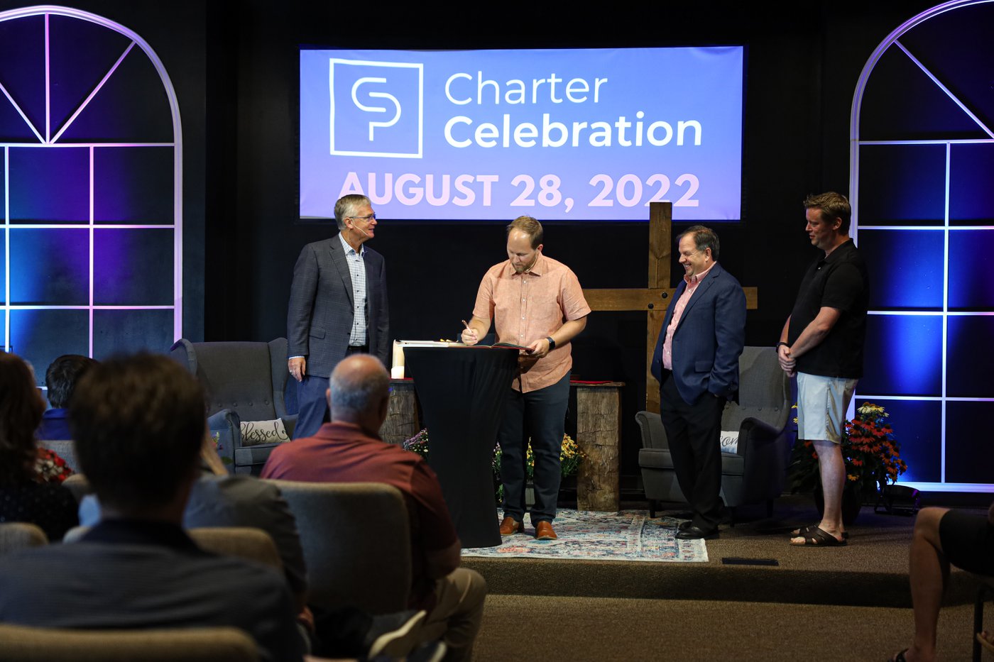 Signing the church charter at the Crosspoint's Charter Celebration service.